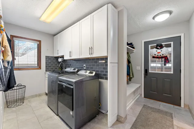 a kitchen with stainless steel appliances granite countertop a stove a refrigerator and a sink