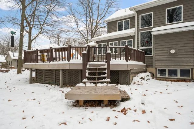 a view of a house with a yard covered in snow