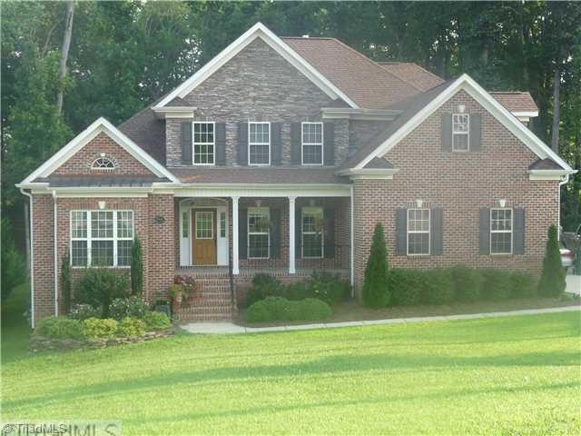 8914 Grove Park Drive Oak Ridge, NC 27310 - Photo 1 of 16 Exterior Front. Gorgeous brick and stacked stone exterior with professional landscaping and rocking chair front porch.