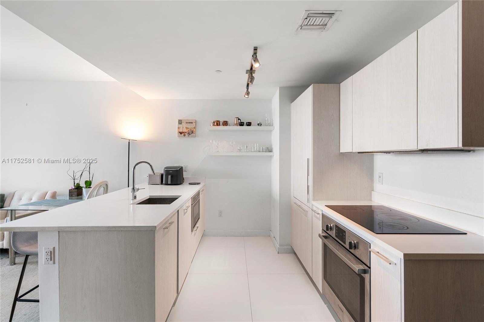 501 Northeast 31st Street, Unit 910 Miami, FL 33137 - Photo 74 of 84 a kitchen with a sink a stove and refrigerator