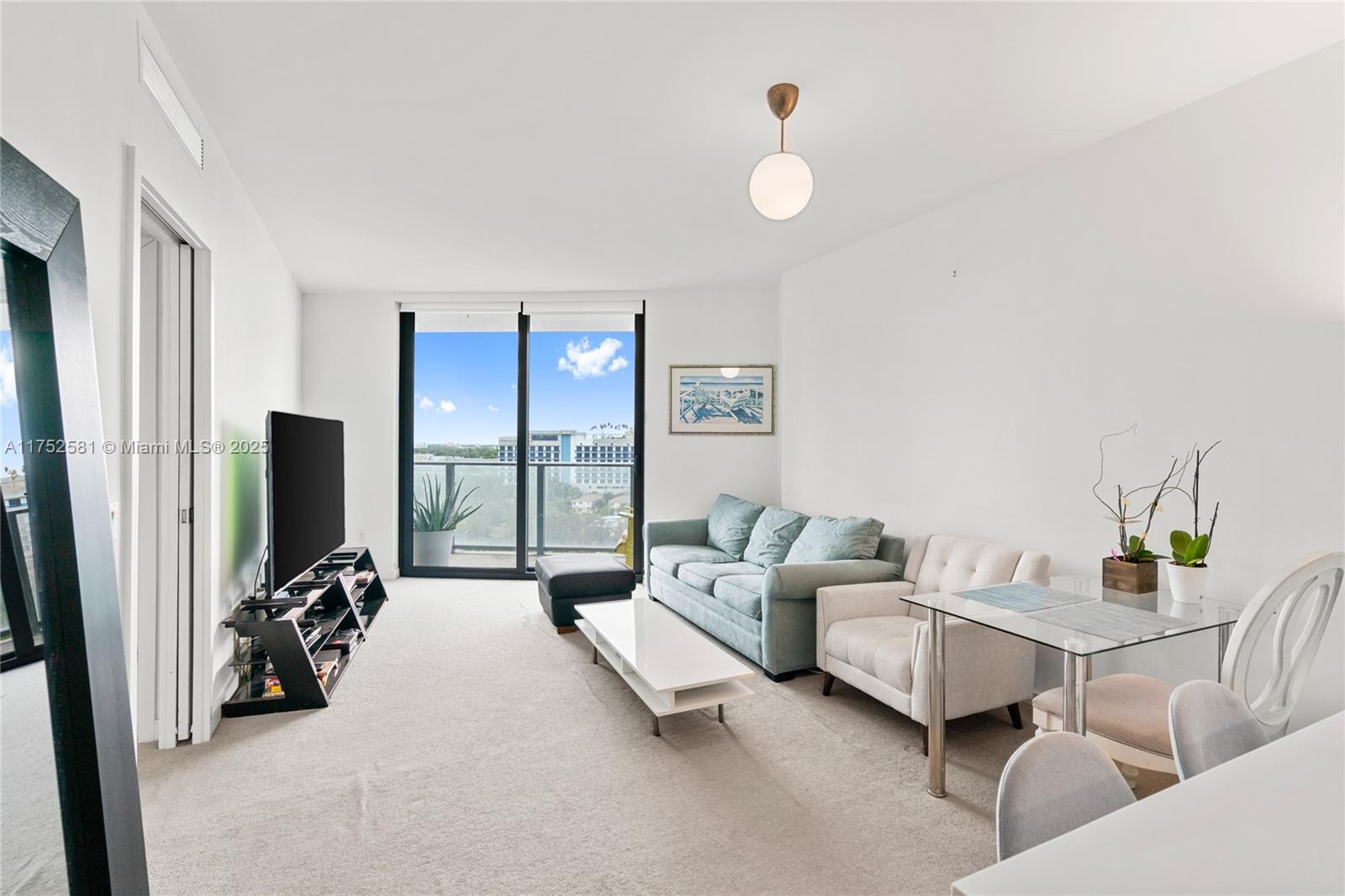 501 Northeast 31st Street, Unit 910 Miami, FL 33137 - Photo 77 of 84 a living room with furniture and a flat screen tv