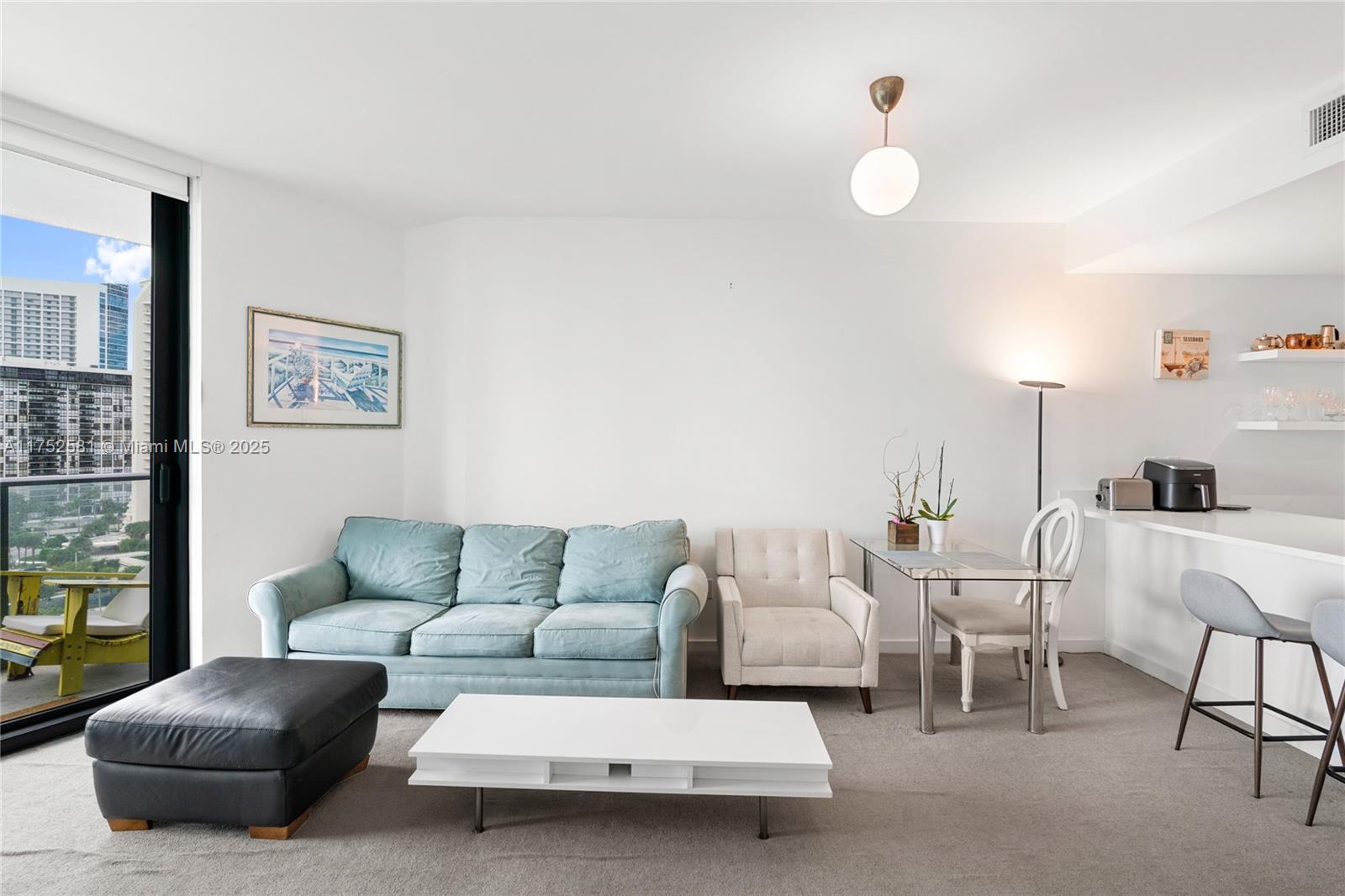 501 Northeast 31st Street, Unit 910 Miami, FL 33137 - Photo 80 of 84 a living room with furniture and a large window