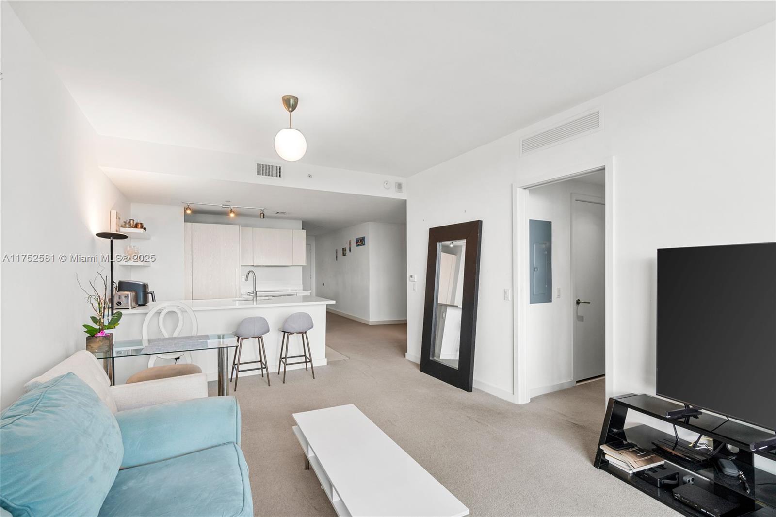 501 Northeast 31st Street, Unit 910 Miami, FL 33137 - Photo 84 of 84 a living room with furniture a flat screen tv and a window