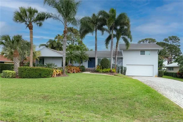a front view of house with yard and outdoor seating