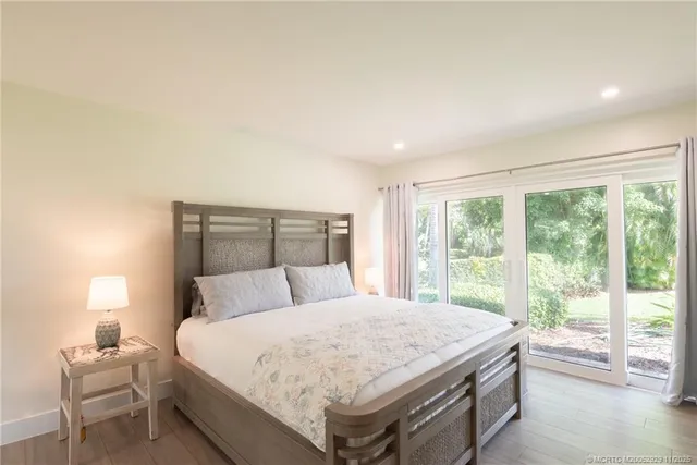 a bedroom with a large bed and a large window