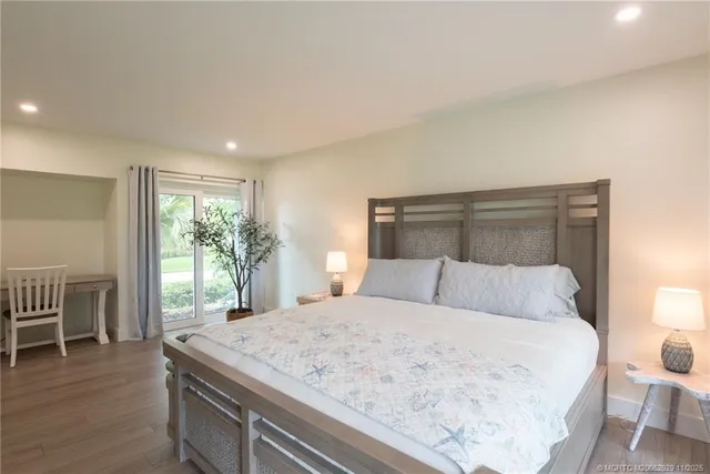 a bedroom with a large bed and a chair