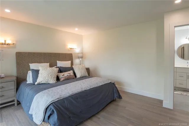 a large bed sitting in a bedroom next to a window