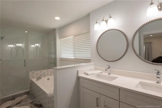 a bathroom with a double vanity sink and a mirror