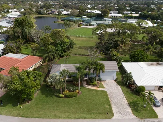 an aerial view of house with yard swimming pool and outdoor seating