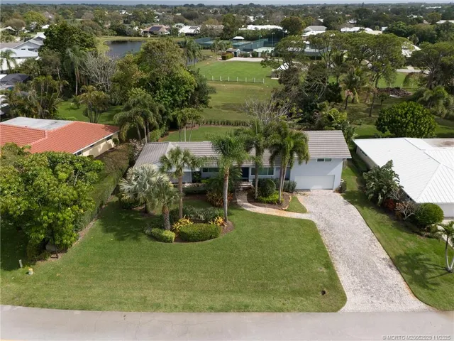 an aerial view of a house with yard swimming pool and outdoor seating