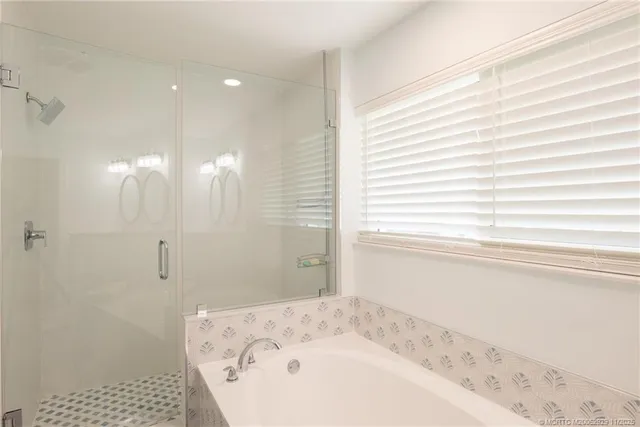 a bathroom with a bathtub and a shower