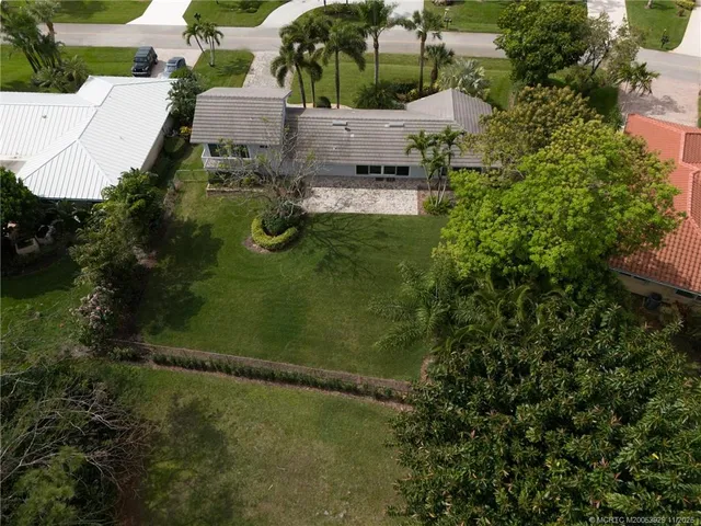an aerial view of a house with a yard