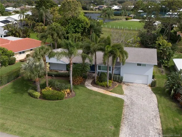 an aerial view of a house with yard swimming pool and outdoor seating