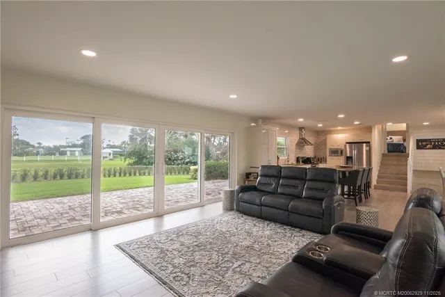 a living room with furniture and a floor to ceiling window