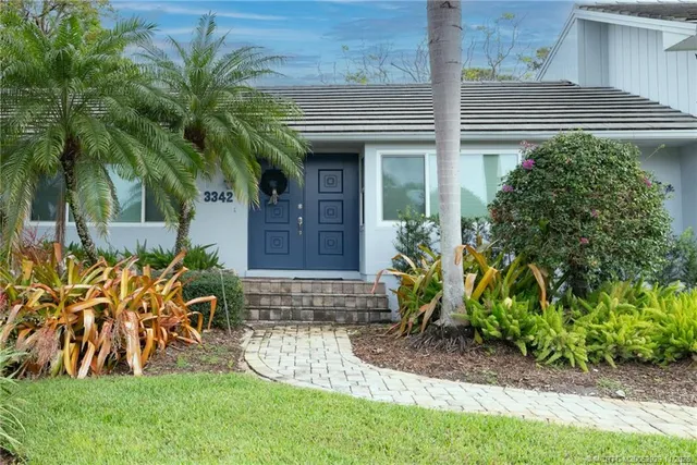 a front view of a house with garden