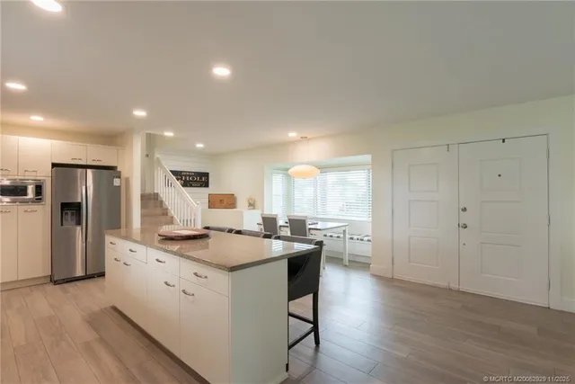 a kitchen with a sink a stove a refrigerator and a oven