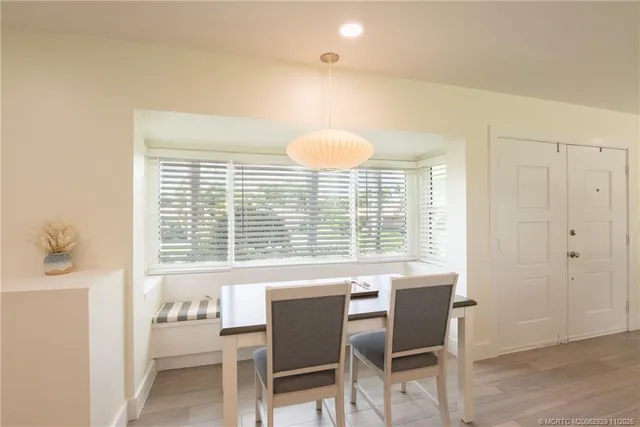 a view of a dining room with furniture and a window