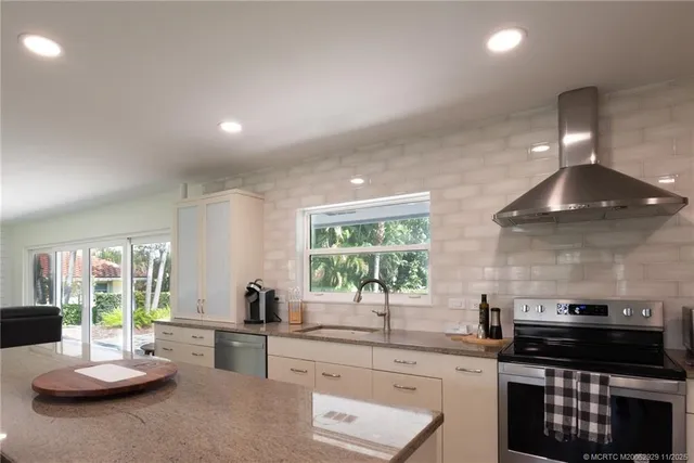 a kitchen with a stove a sink and a stove