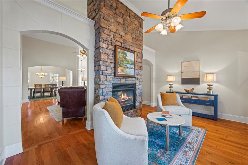 80 Hardy Farms Point Martin, GA 30557 - Photo 23 of 84 a living room with furniture a fireplace and a chandelier