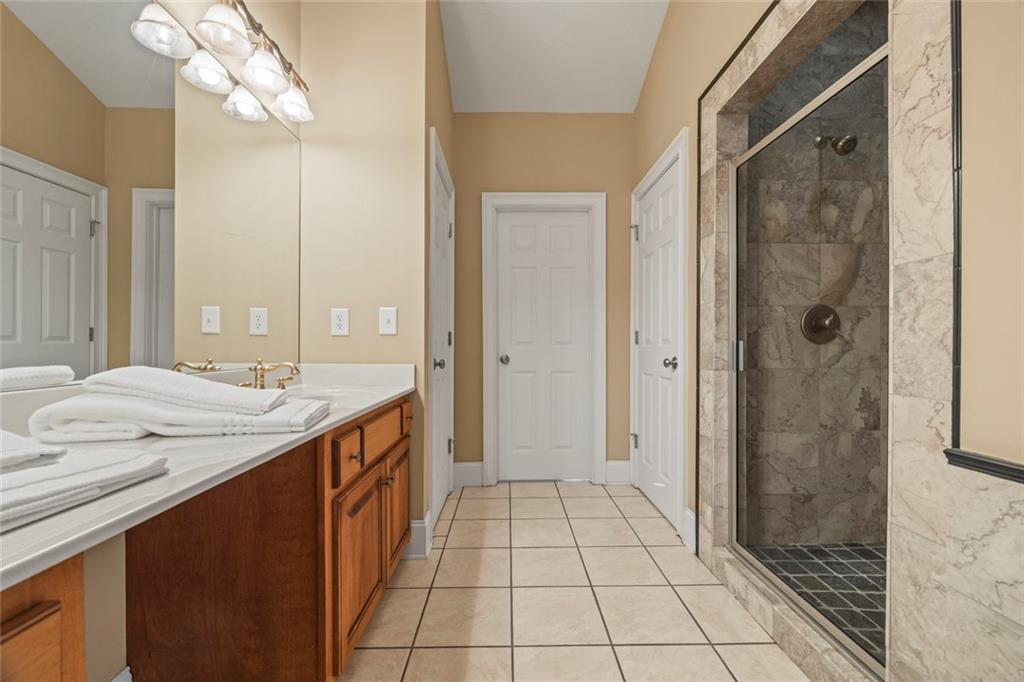 80 Hardy Farms Point Martin, GA 30557 - Photo 43 of 84 a spacious bathroom with a granite countertop sink a mirror and a shower