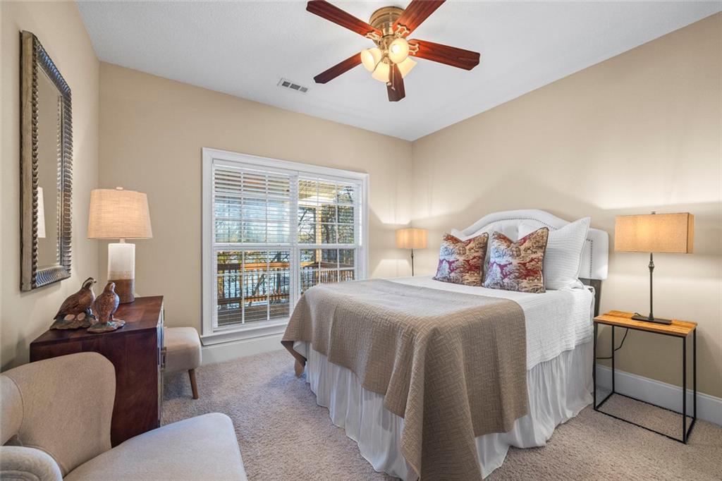 80 Hardy Farms Point Martin, GA 30557 - Photo 55 of 84 a bedroom with a bed and a chandelier