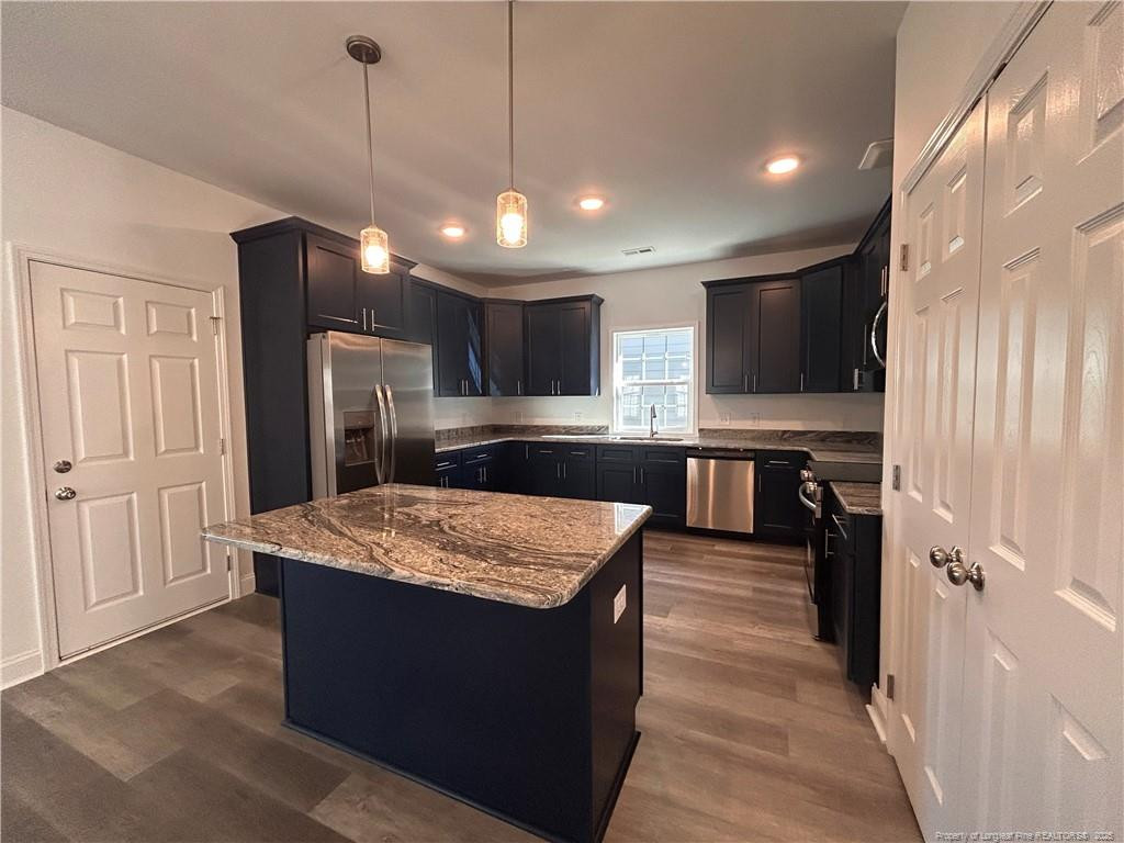 407 Morehead Street Spring Lake, NC 28390 - Photo 3 of 12 a large kitchen with kitchen island a sink stainless steel appliances and cabinets