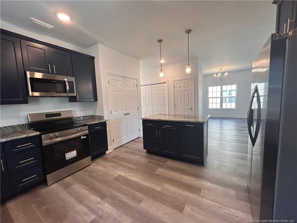 407 Morehead Street Spring Lake, NC 28390 - Photo 4 of 12 a large kitchen with kitchen island granite countertop stainless steel appliances and a sink