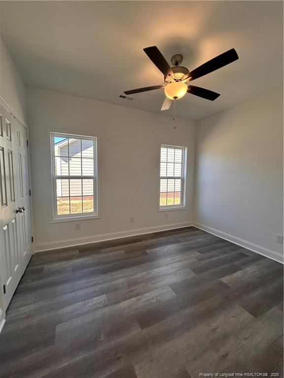 407 Morehead Street Spring Lake, NC 28390 - Photo 10 of 12 an empty room with wooden floor fan and windows