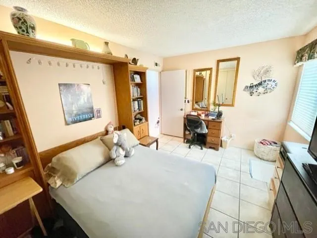 119 Linaza Lane Spring Valley, CA 91977 - Photo 16 of 36 a bedroom with a bed and wooden floor