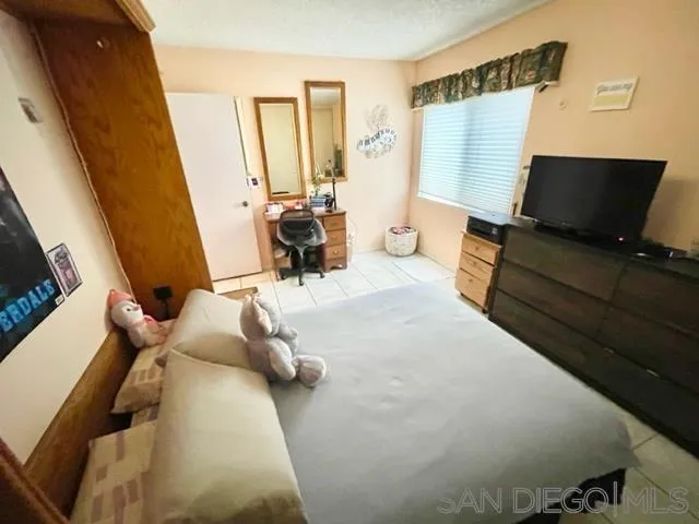 119 Linaza Lane Spring Valley, CA 91977 - Photo 17 of 36 a bedroom with furniture and a window