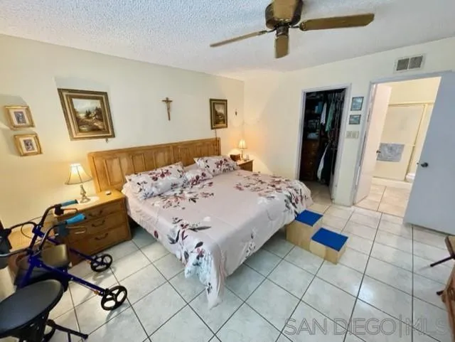 119 Linaza Lane Spring Valley, CA 91977 - Photo 19 of 36 a bed sitting in a bedroom next to a window with pc on the table