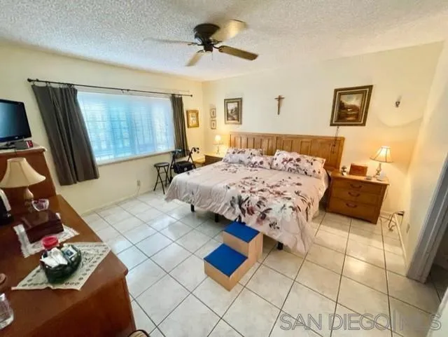119 Linaza Lane Spring Valley, CA 91977 - Photo 20 of 36 a bedroom with a bed and a couch
