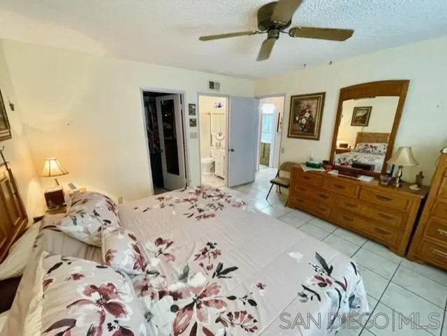 119 Linaza Lane Spring Valley, CA 91977 - Photo 21 of 36 a bedroom with a bed and wooden floor