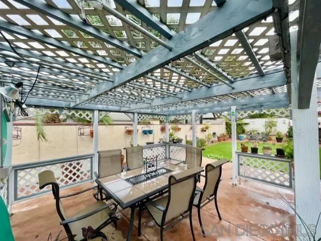 119 Linaza Lane Spring Valley, CA 91977 - Photo 34 of 36 a view of a patio with a table and chairs and couches with wooden floor and fence