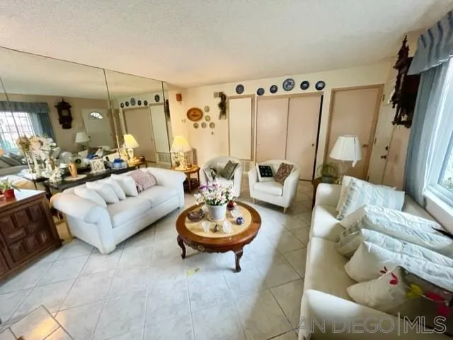 119 Linaza Lane Spring Valley, CA 91977 - Photo 5 of 36 a living room with furniture a rug and a large window