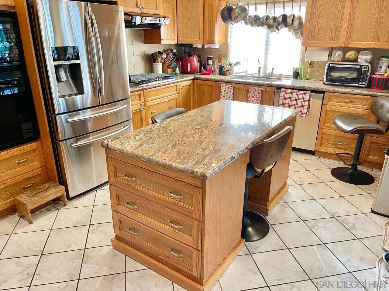 119 Linaza Lane Spring Valley, CA 91977 - Photo 7 of 36 a kitchen with stainless steel appliances granite countertop a sink and a refrigerator