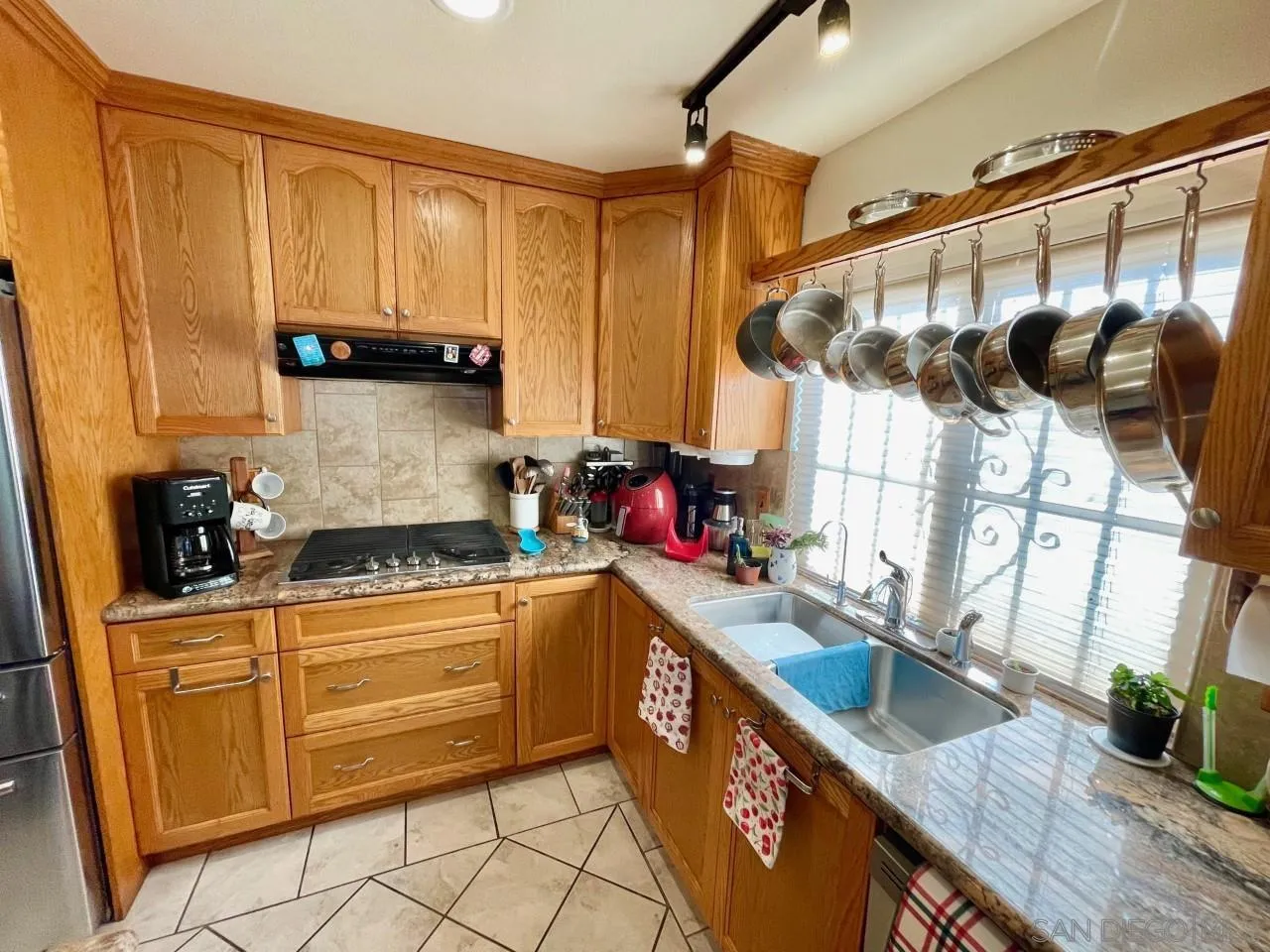 119 Linaza Lane Spring Valley, CA 91977 - Photo 8 of 36 a kitchen with stainless steel appliances granite countertop a sink a stove and a wooden cabinets