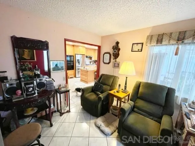 119 Linaza Lane Spring Valley, CA 91977 - Photo 10 of 36 a living room with furniture and a flat screen tv