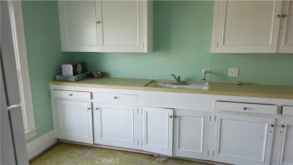 a kitchen with a sink and cabinets