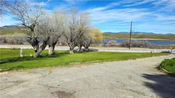 a view of a backyard with ocean view