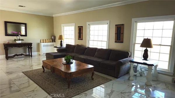 a living room with furniture a dining table and a window
