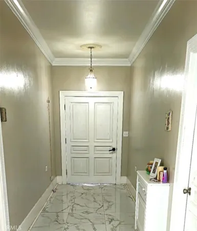 a view of a hallway with closet and chandelier