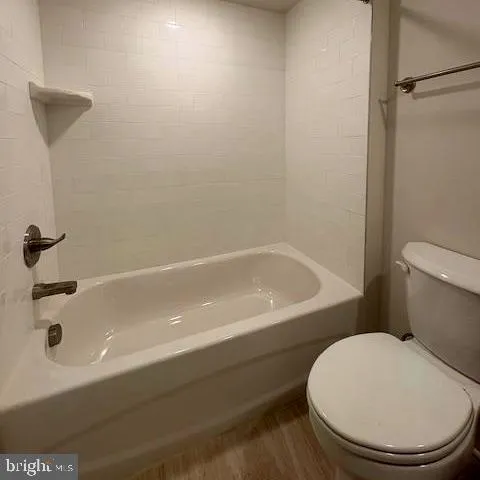 a bathroom with a bathtub and a toilet