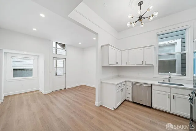a kitchen with a sink cabinets and window