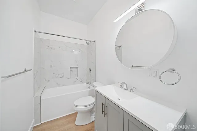 a spacious bathroom with a sink a toilet and shower
