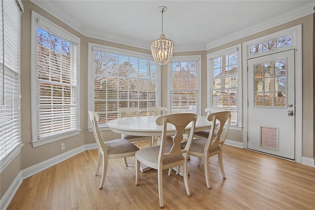 2018 Cockrell Pointe Northwest Kennesaw, GA 30152 - Photo 13 of 51 a view of a dining room with furniture large windows and wooden floor
