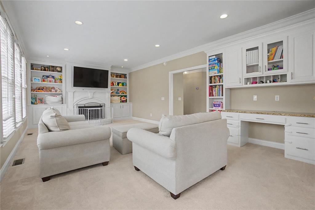 2018 Cockrell Pointe Northwest Kennesaw, GA 30152 - Photo 14 of 51 a living room with furniture a fireplace and a flat screen tv