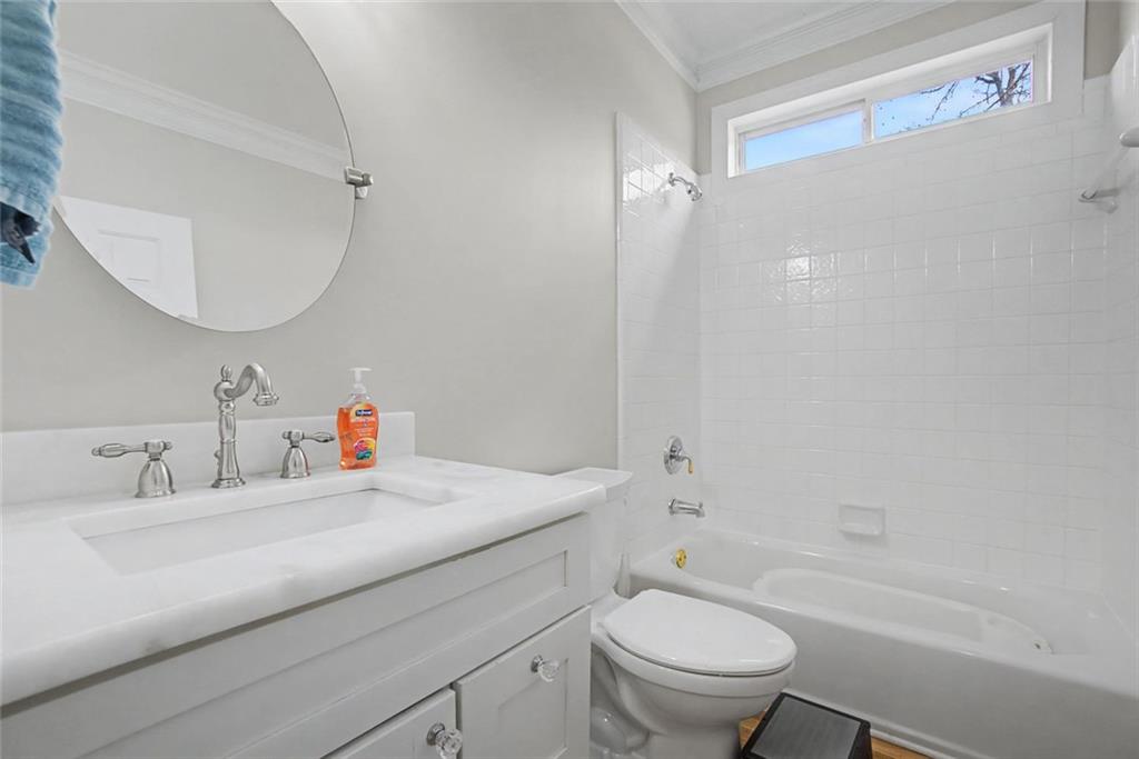 2018 Cockrell Pointe Northwest Kennesaw, GA 30152 - Photo 16 of 51 a bathroom with a sink a toilet and a mirror