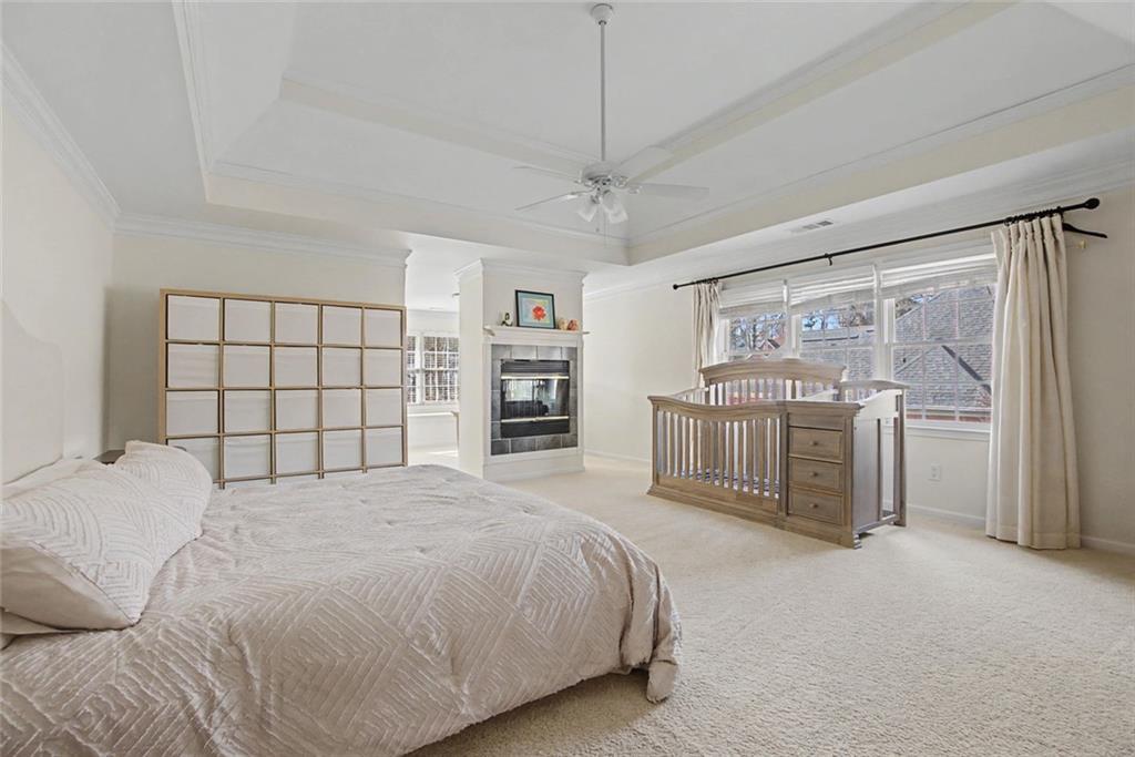 2018 Cockrell Pointe Northwest Kennesaw, GA 30152 - Photo 17 of 51 a spacious bedroom with a bed and cabinets