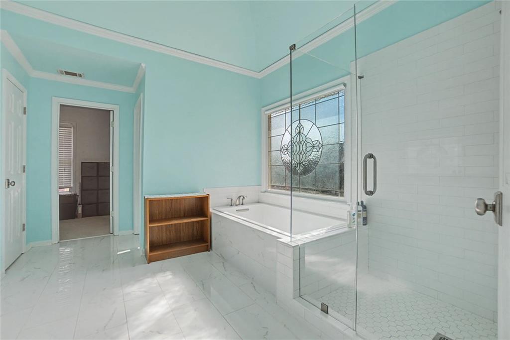 2018 Cockrell Pointe Northwest Kennesaw, GA 30152 - Photo 21 of 51 a spacious bathroom with a tub and a shower